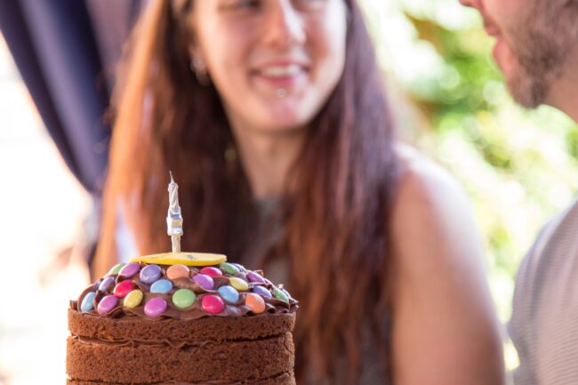 image of woman with her birthday cake to help visualise likelihood of developing varicose veins after a certain age