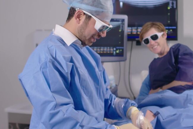 Dr Zil Yassine performing a varicose vein treatment. Both he and the patient are smiling